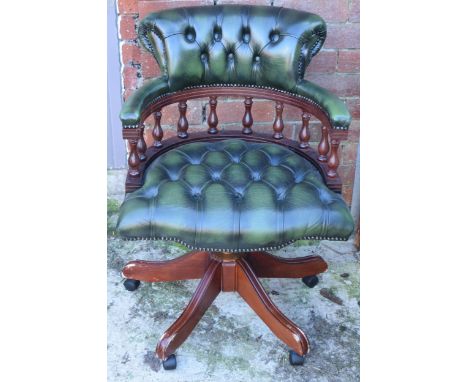 Chesterfield-style button back swivelling captains chair in green leather, 90cm tall.  Leather is generally in good condition