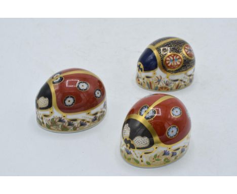 Royal Crown Derby paperweights to include a blue ladybird, a red ladybird with seven spots, both first quality with gold stop