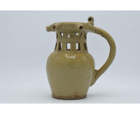 Early 19th century stoneware puzzle jug with pierced design in light glaze (unmarked), one section missing, 20.5cm tall.  One