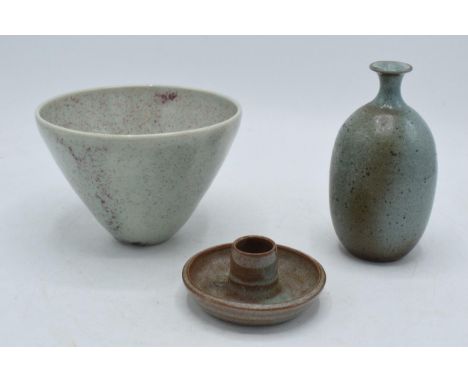 A trio of studio pottery items to include a bowl, a candlestick and a vase (3), makers marks to base.  In good condition with