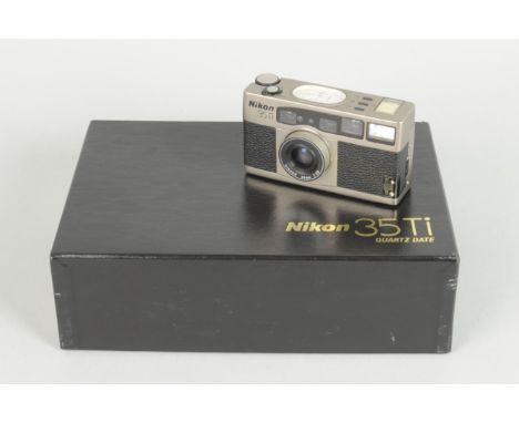 A Nikon 35Ti Quartz Date Compact Film Camera, titanium body, serial no. US 4 016 711, body VG, powers up, shutter working on 