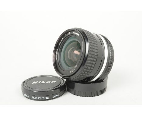 A Nikon Nikkor 24mm f/2.8 AI Lens, serial no 601499, barrel G, light wear,elements G-VG, slight internal dust, with maker's c