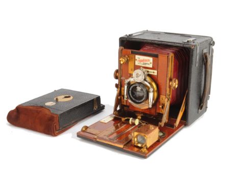 An early 20th Century mahogany and brass and leather-covered 3in x 4in Houghton 'Sanderson' Hand and Stand Camera,  with Aldi