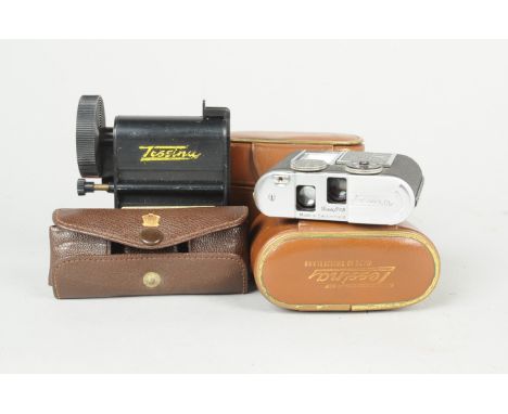 A Tessina L Miniature 35mm Camera, chrome, body G, with 25mm f/2.8 lens, a wrist strap, six film canisters, four with film ca