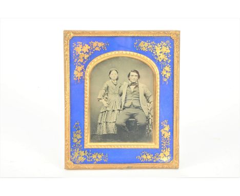 A Quarter-Plate Portrait Ambrotype,  seated father, with right arm around his daughter standing to his idea, framed and glaze