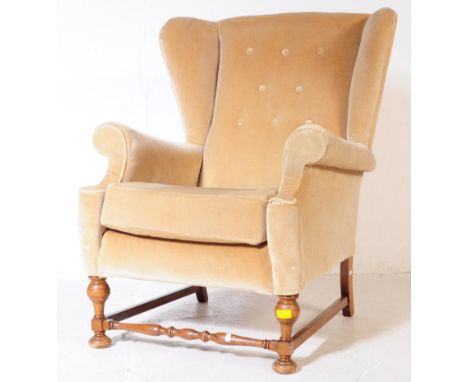 A vintage 20th century circa 1970s wing back armchair / lounge chair. In a green / yellow upholstered fabric, wing back with 