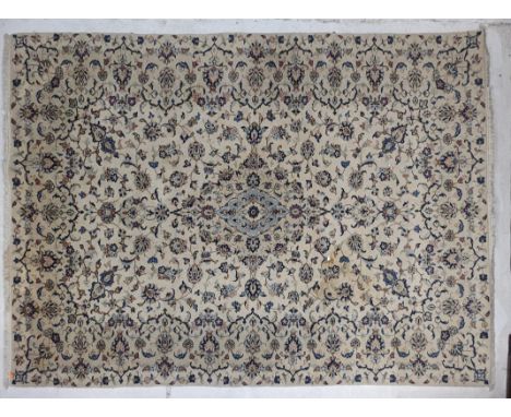 A vintage 20th century Persian Islamic carpet floor rug. Rectangular form with repeating floral and geometric pattern in blue