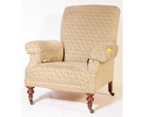 A vintage 20th century lounge fireside armchair. Having a cushioned upright backrest, into curved arm elbow rests, all raised