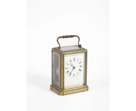 A brass cased carriage clock, early 20th Century, the white enamel dial bearing Roman numerals, drum barrel, with glass sides