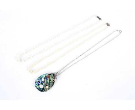 Two strings of pearls and a necklace with a ceramic pendant. All with silver clasps
