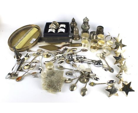 An assortment of silver plate. Including napkin rings, spoons, an Art Nouveau style comb, etc