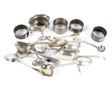 An assortment of 19th and 20th century silver. Comprising four napkin rings, a mustard pot and multiple spoons, 318 grams gro