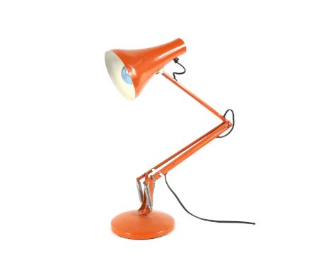 A Herbert Terry orange anglepoise desk lamp, on circular base. Model 90, base diameter 19cm.
