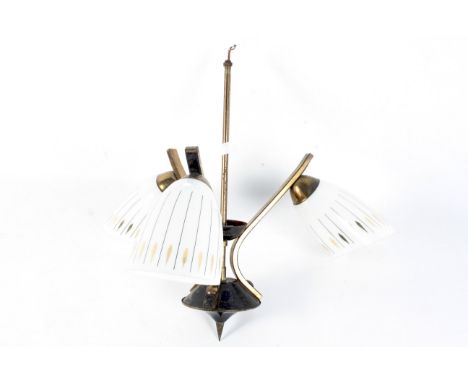 A 1960s three-light ceiling pendant. With white opaque shades with gilt and black ornament, issuing from three gilt metal bra