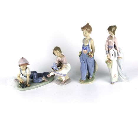 Four Lladro Collectors Society figures. Two depicting children playing with toys, another of a girl wearing dungarees and the