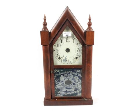 A late 19th century mahogany cased American mantel clock. Of arched architectural form, white painted dial with black Arabic 