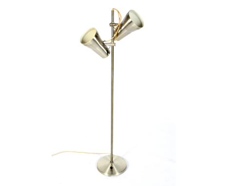 A brushed metal adjustable floor lamp. With two spot lights on a single column, 125cm high.