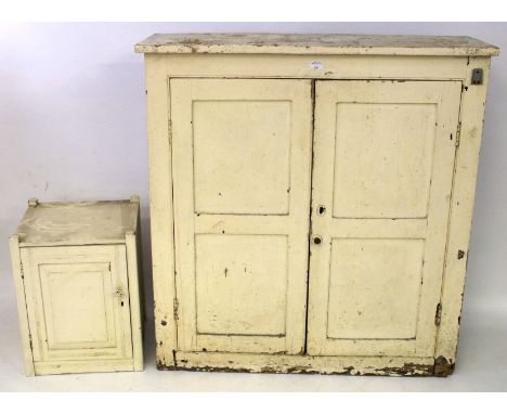 A vintage white painted mahogany cupboard and a pot cupboard. The first with a pair of panelled doors opening to reveal two s