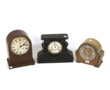 Three 20th century mantel clocks. Comprising one with Arabic numerals and in an oak case, 23cm high, another with Roman numer