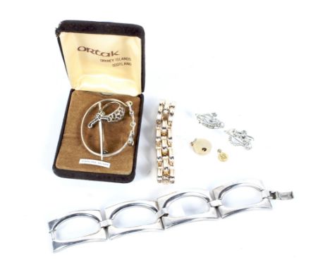 An assortment of silver and costume jewellery. Including a silver bangle with stirrup clasp, a sword-shaped brooch and a ring