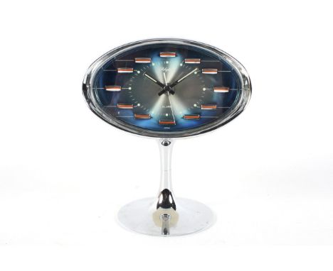A retro Rhythm (Japan) alarm clock, circa 1960s. With oval blue tinted face and chromed edge of case and tulip-shaped base, m
