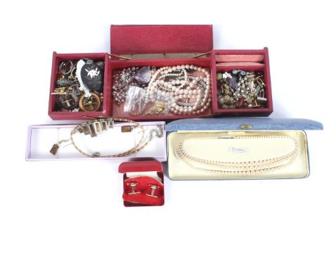 An assortment of costume jewellery. Including an enamel brooch, pair of earrings constructed from mother of pearl fish counte