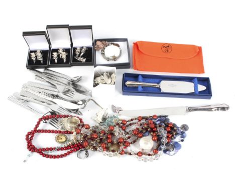 An assortment of costume jewellery. Including a ring, necklaces, bracelets, etc, together with a silver handled knife