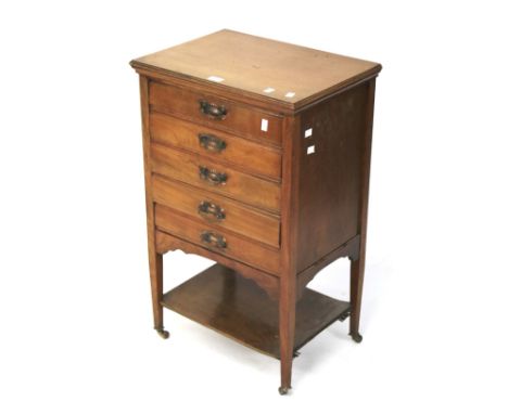 A light oak music storage cabinet. Five drawers with drop fronts and copper swing handles, on castors. L52 x D37 x H83cm.