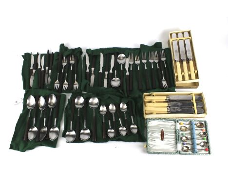 An assortment of flatware. Including serving spoons, a nut cracker, candle snuffer, etc