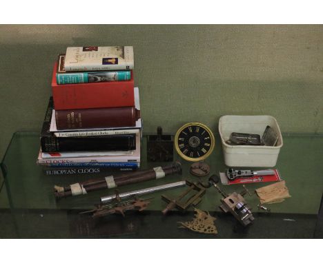 An assortment of watch and clock tools, components and books. To include an assortment of precision tools and watch opener, t