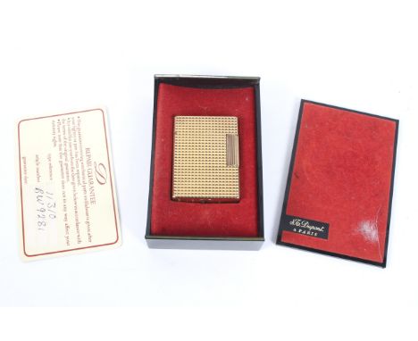 A boxed Dupont gold plated pocket lighter. Textured exterior, in a fitted box with a repair card