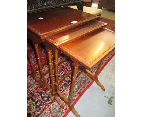 Nest of three reproduction rectangular mahogany occasional tables on twin turned end supports together with a reproduction ma