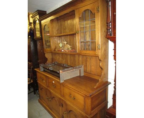 Good quality reproduction oak dresser with a boarded shelf and cupboard back above three drawers and three fielded panelled d