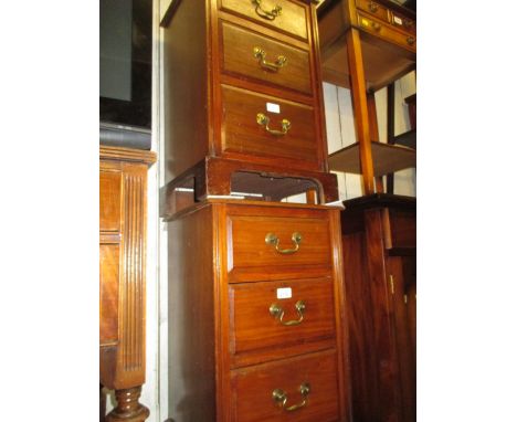 Pair of walnut three drawer bedside cabinets on bracket supports