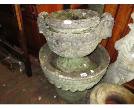 Large cast concrete garden planter with a pedestal base together with two similar smaller planters