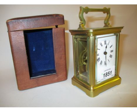 Small brass cased carriage clock with enamel dial and Roman numerals, single train movement and original travel case