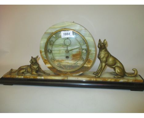 Art Deco black slate and green onyx mantel clock mounted with gilded figures of dogs together with a similar clock base mount