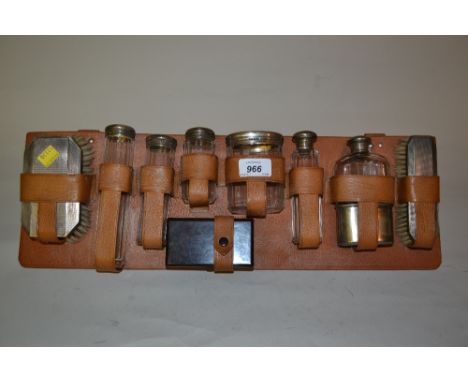 Silver mounted dressing table set on a leather stand including a hip flask with a plated cup