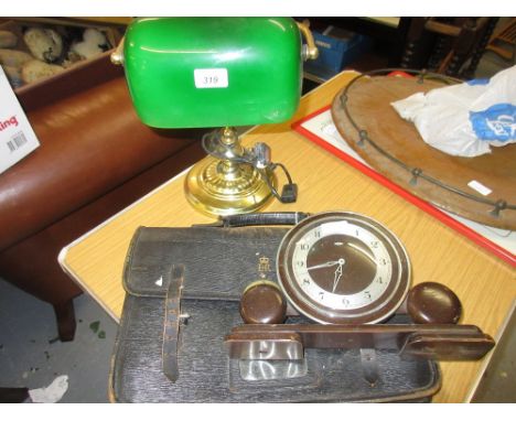 Brass table lamp with a green glass shade, Art Deco mantel clock, and a leather briefcase, inscribed Elizabeth II