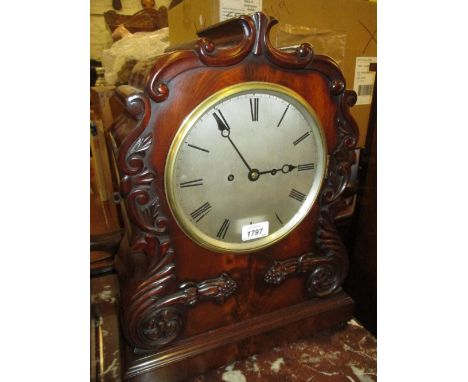 William IV mahogany bracket clock, the shaped case with applied carved floral decoration, the circular silvered dial with Rom