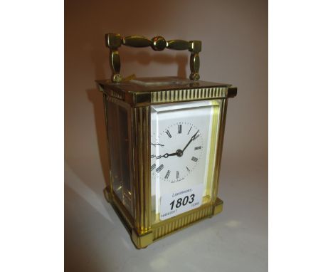 20th Century brass cased carriage clock with enamel dial having Roman numerals and winding key