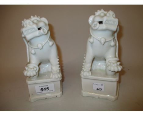 Pair of Chinese blanc de chine joss stick holders in the form of Kylin dogs, 6.75ins high