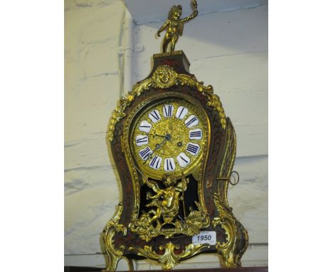 Late 19th / early 20th Century Buhl mantel clock, the shaped case with winged figure surmount, the gilt dial with enamel cart