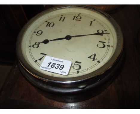 Small circular Bakelite cased bulk head clock with a hinged chrome plated bezel, 7ins diameter