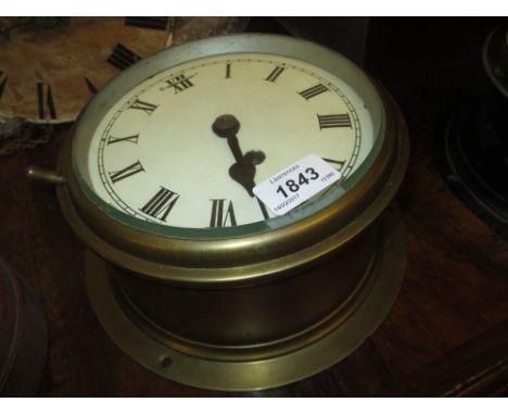 Brass cased ship's bulk head clock, the enamel dial with Roman numerals and single train key wind movement, 9.25ins diameter