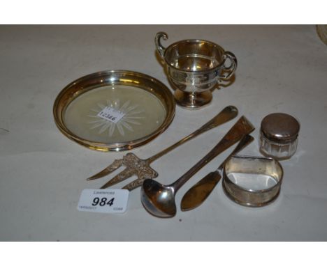 Silver mounted etched glass coaster, small silver trophy cup, toasting fork, ladle, butter knife, serviette ring and silver m