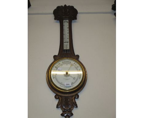 Carved oak aneroid barometer / thermometer by Aitchinson and Co., London, 33ins long