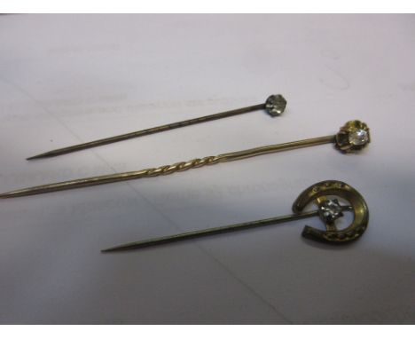 Victorian yellow metal and diamond set stick pin and two paste stick pins