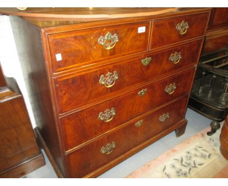 Figured walnut crossbanded and chevron inlaid straight front chest, the caddy moulded top above two short and three long grad