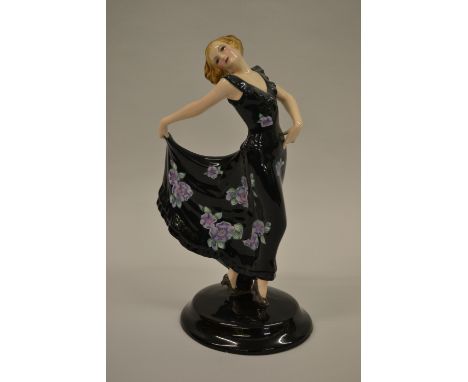 Goldscheider figure of a girl wearing a floral decorated dress (slight chip to base and finger a/f)